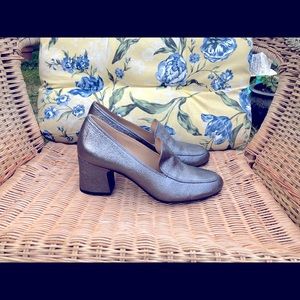 Silver colored soft leather heeled loafers.